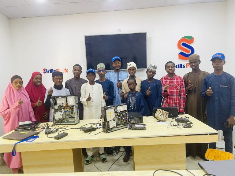 Community members learning computer hardware basics during a free SkillsPark practical workshop.