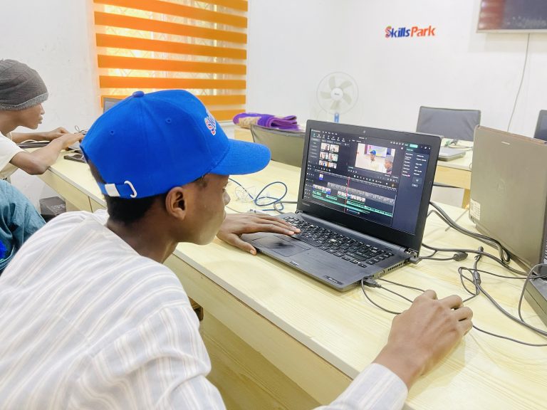 A participant practising video editing on a laptop during SkillsPark training.