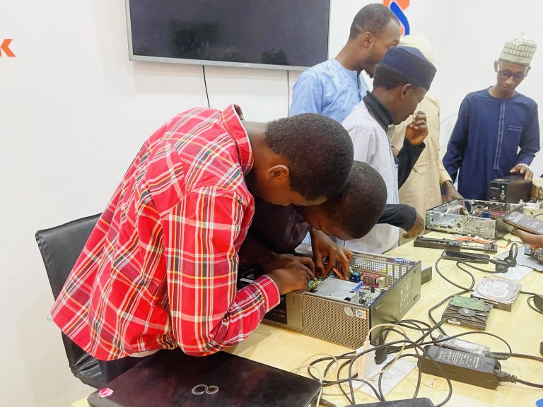 Participants working on an open desktop computer during SkillsPark hardware training.